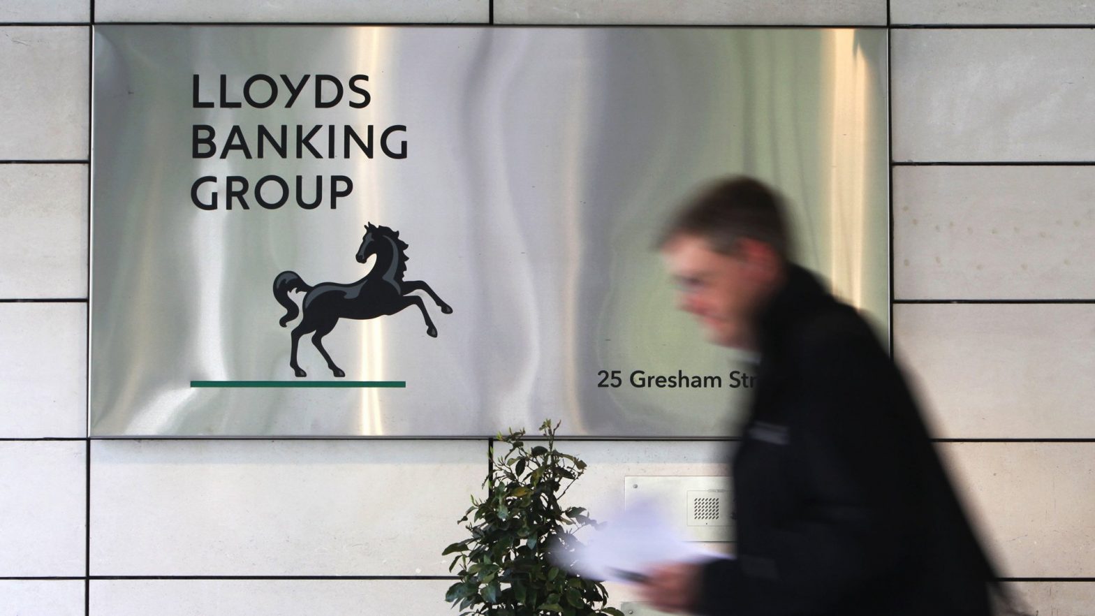 Lloyds Banking Group Plc. Headquarters...A pedestrian walks past